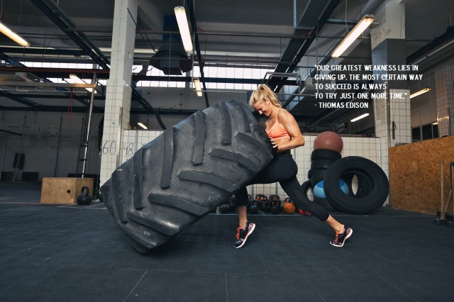Crossfit Woman Flipping A Huge Tire At Gym